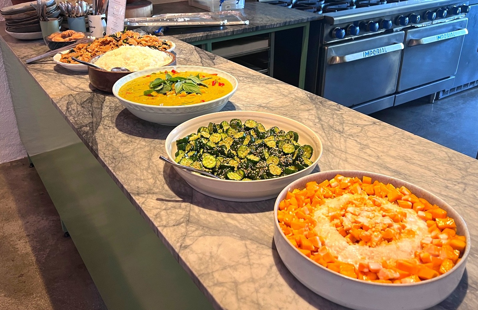 Rice & Shine corporate catering spread with bowls of fresh Asian dishes