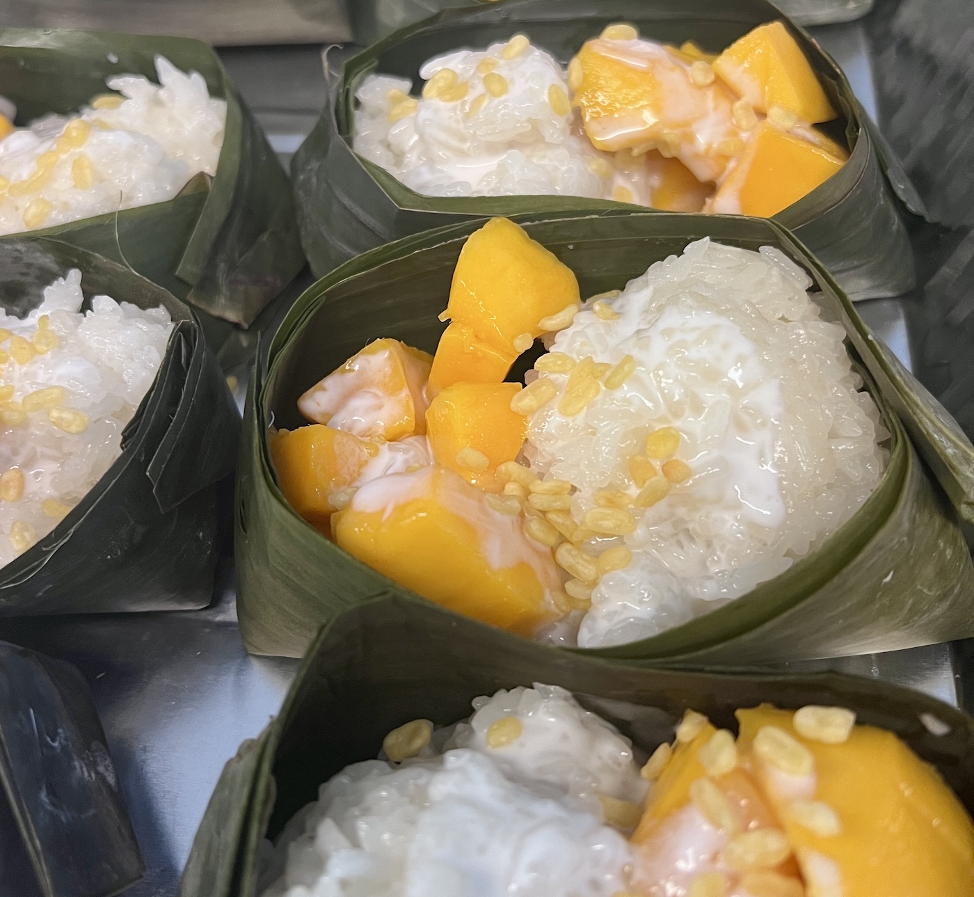 Mango sticky rice served in banana leaf — Southeast Asian street food by Rice & Shine