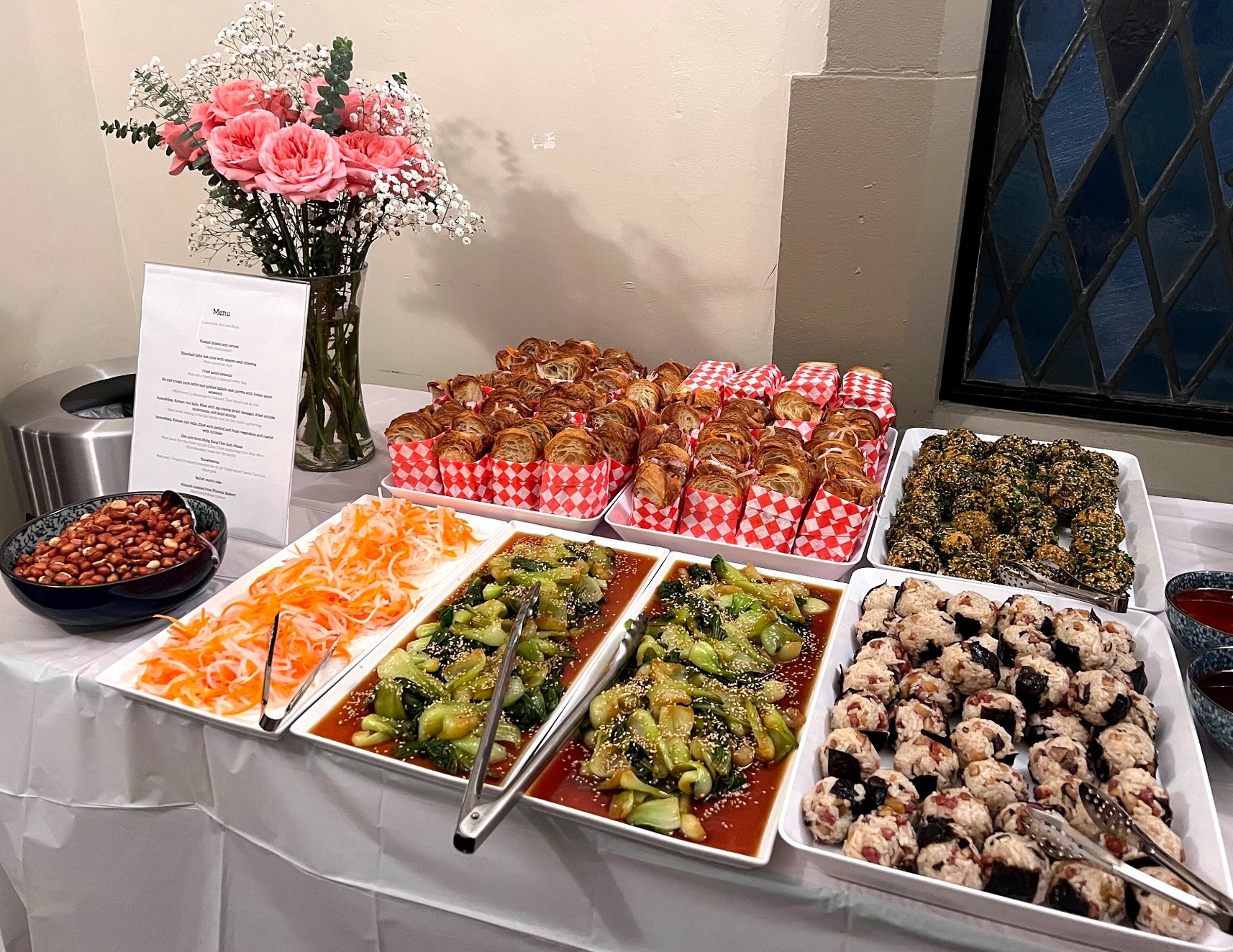 Rice & Shine catering spread for a private event with assorted dishes and florals
